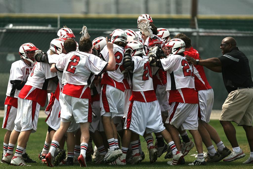 Photo by Pixabay: https://www.pexels.com/photo/group-of-lacrosse-players-celebrating-with-coach-during-daytime-159728/